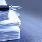 Ballpoint Pen Resting On Top Of Stack Of Documents stock photo